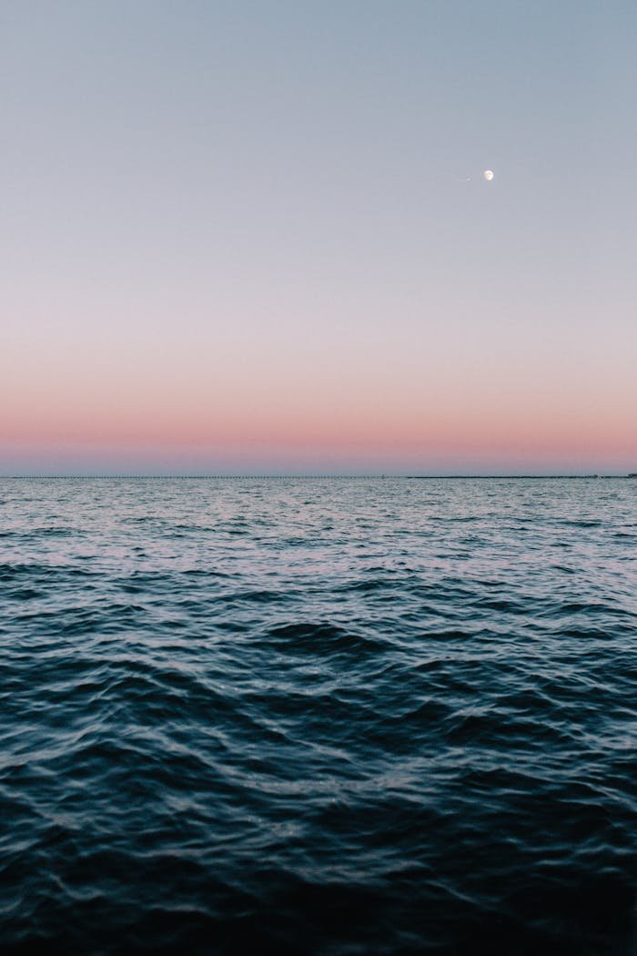 Tranquil twilight sea view in Norfolk, VA, with calming waves and pastel sky hues.